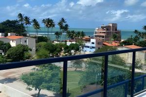 a view of the ocean from a balcony at Condomínio Pérola de Porto in Ipojuca