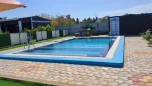 a swimming pool in a yard with a house at Boomerank Inn in Rāmeswaram