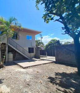 a house with a gate and a fence at La Casa de MiNi in La Ceiba