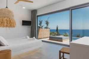 a bedroom with a bed and a view of the ocean at Zante Fiore Suites in Xirokástellon +189 photos