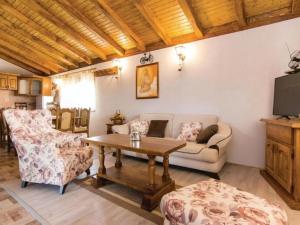 a living room with a couch and a table at Three bedroom Vila with Pool in Stankovci