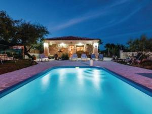 a swimming pool in front of a house at night at Three bedroom Vila with Pool in Stankovci