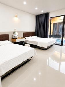a bedroom with two beds and a window at Minh chau riverside in Quang Ninh