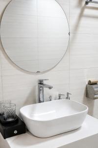 a white sink in a bathroom with a mirror at Minh chau riverside in Quang Ninh