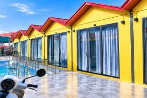 a scooter parked in front of a yellow building at Minh chau riverside in Quang Ninh