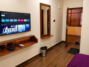 a room with a flat screen tv on a wall at Hotel Lavish Grand in Tenāli