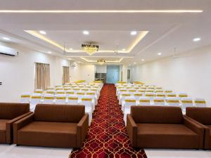 a large room with rows of chairs and a stage at Hotel Lavish Grand in Tenāli