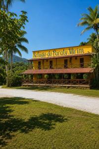 a yellow building with a sign that reads ricothe do paraly infinity at Refúgio do Paraty Mirim in Paraty