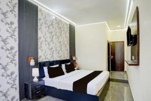 a bedroom with a large bed in a room at Raj Embassy in Rudrapur