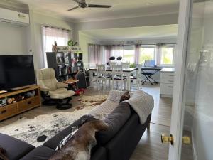 a living room with a couch and a dining room at Large bedroom 2 King Single beds Centrally located in Jesmond