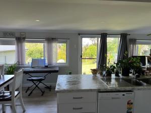 a kitchen with a counter and a table and windows at Large bedroom 2 King Single beds Centrally located in Jesmond