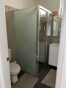 a bathroom with a toilet and a glass shower at Large bedroom 2 King Single beds Centrally located in Jesmond +14 photos