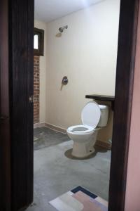 a bathroom with a toilet in a room at Hotel las carretas , spa y temazcal in Zacatlán +66 photos