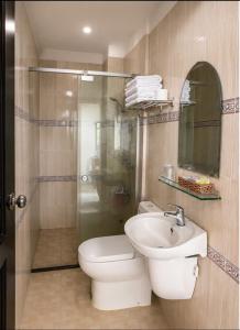 a bathroom with a toilet and a sink at Trung Hậu Hotel Côn Đảo in Con Dao +24 photos