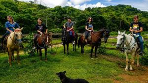 a group of people on horses and a dog at Refúgio do Paraty Mirim in Paraty