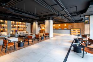 a restaurant with tables and chairs and a lobby at INNSiDE by Meliá Madrid Valdebebas in Madrid