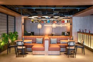 a restaurant with a couch and tables and chairs at INNSiDE by Meliá Madrid Valdebebas in Madrid