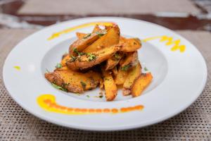 a plate of food with french fries on a table at Hotel Dreams Connect GRB 2 in Kathmandu