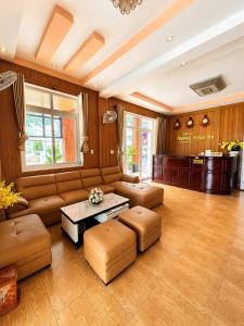 a living room with a couch and a table at Trung Hậu Hotel Côn Đảo in Con Dao