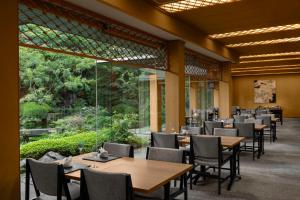 a restaurant with tables and chairs and a large window at ANA InterContinental Tokyo by IHG in Tokyo