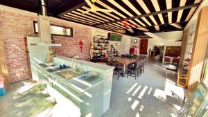 a kitchen and dining room with a brick wall at My Home 51-6 in Gongguan