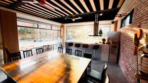 a dining room with a long table and chairs at My Home 51-6 in Gongguan