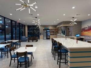 a restaurant with tables and chairs and a bar at Clarion Pointe Port Lavaca in Port Lavaca