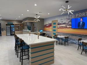 a lobby with a bar with chairs and a welcome to portland sign at Clarion Pointe Port Lavaca in Port Lavaca