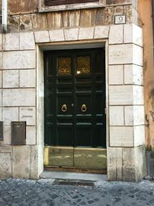 a large black door on a building with the number at Pantheon Old Suite in Rome