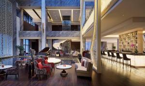 a lobby of a hotel with tables and chairs at Gran Meliá Xian in Xi'an