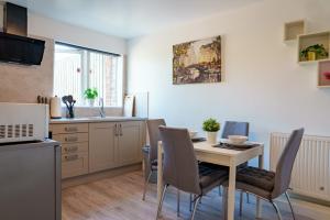 a kitchen and dining room with a table and chairs at Charles House in Chatham