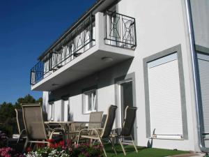a balcony with chairs and a table on a house at Slanraj Studio in Jadrtovac
