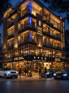 a building with people walking in front of it at Eve Service apartment in Mysore