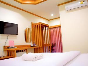 a hotel room with a bed and a television at Loei Residence in Ban Tha Phae +87 photos