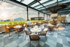 a restaurant with tables and chairs and a view at Meliá Vinpearl Tay Ninh in Tây Ninh