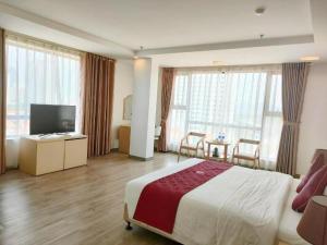 a hotel room with a bed and a flat screen tv at Smart Hotel in Bắc Ninh