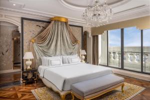 a bedroom with a white bed and a chandelier at Meliá Vinpearl Tay Ninh in Tây Ninh +52 photos