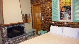 a bedroom with a bed and a fireplace at Mathes in Kl&aacute;vsion