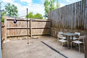 a table and chairs in front of a fence at Charles House in Chatham