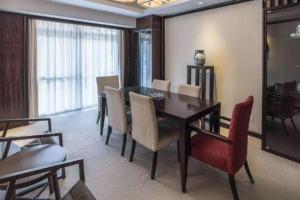 a dining room with a table and chairs at Tiantai Hotel in Wachangtan