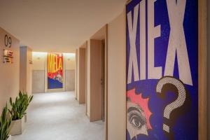 a hallway with a large painting on the wall at INNSiDE by Meliá Bugibba in St. Paul's Bay