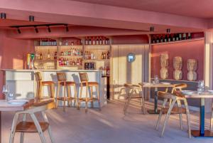 a restaurant with tables and chairs and a bar at INNSiDE by Meliá Bugibba in St. Paul's Bay +55 photos