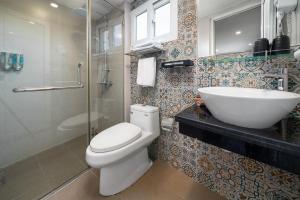 a bathroom with a toilet and a sink and a shower at TRUNG - The Coffee House in Hanoi +19 photos