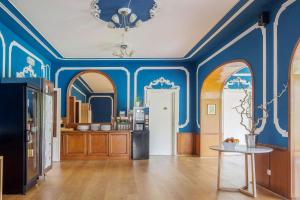 a living room with blue walls and a table at Hotel Auronzo Dolomites, Affiliated by Melia in Auronzo di Cadore