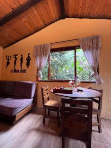 a living room with a table and a couch at Casa del Río, Vilcabamba in Loja