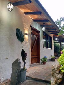 a house with a plant in front of a door at Casa del Río, Vilcabamba in Loja