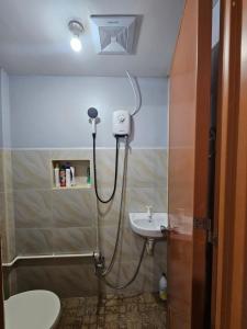 a bathroom with a shower and a sink at IBM Homestay in Butuan +14 photos