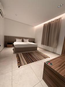 a bedroom with a bed and a rug at NOOR iNN , Prime Location, SelfEntry in Medina