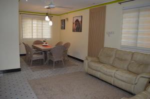 a living room with a couch and a table at Masaki Comfort III Dar es Salaam Tanzania in Dar es Salaam