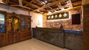 a restaurant with a bar with a tv on the wall at Harshavardhana Inn in Kizhake Chālakudi